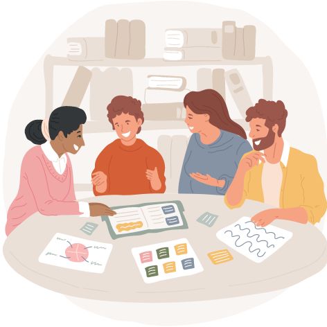 A group of people sitting at a table looking at a book
Description automatically generated